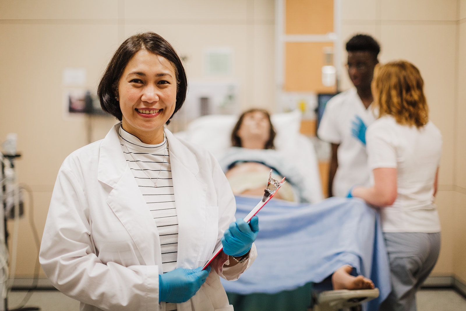 USask students and an instructor working on a birthing simulation at the CLRC